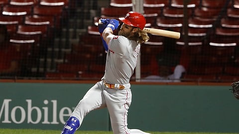 Philadelphia Phillies' Bryce Harper follows through on his three run home run against the Boston Red Sox during the sixth inning of a baseball game Tuesday, Aug. 18, 2020, at Fenway Park in Boston.