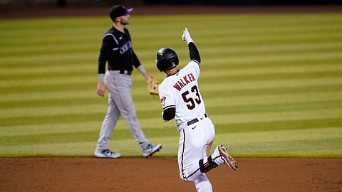 A scene Eckel would like to see repeated: Arizona Diamondbacks' Christian Walker (53) rounds the bases after hitting a solo home run as Colorado Rockies' Trevor Story looks away during the fourth inning of a baseball game, Monday, Aug. 24, 2020, in Phoenix. 
