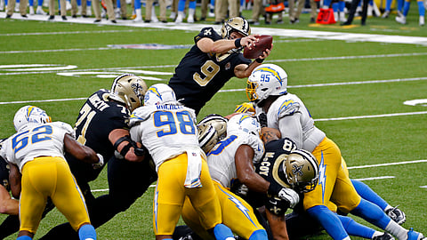 New Orleans Saints quarterback Drew Brees (9) dives over the goal line for a touchdown in the first half of an NFL football game against the Los Angeles Chargers in New Orleans, Monday, Oct. 12, 2020. 