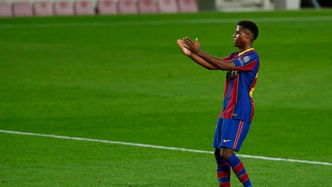 Barcelona's Ansu Fati celebrates after scoring his side's second goal during the Champions League group G soccer match between FC Barcelona and Ferencvaros at the Camp Nou stadium in Barcelona, Spain, Tuesday, Oct. 20, 2020.