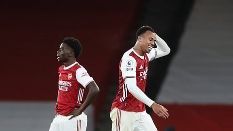Arsenal's Gabriel, right, leaves the pitch after being sent off for a foul on Southampton's Theo Walcott, bottom, during an English Premier League soccer match between Arsenal and Southampton at the Emirates stadium in London, England, Wednesday, Dec. 16, 2020. 
