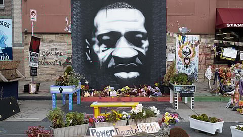 Flowers and signs outside the location of George Floyd's death in Minneapolis, Minnesota in Minneapolis, Minnesota, U.S., on Sunday, Oct. 24, 2021. More than a year after George Floyd was killed, voters in Minneapolis are about to decide on a mayor, every member of the city council — and a measure to overhaul the police department.