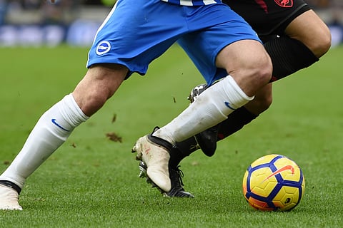 A Brighton and Hove Albion FC football player, left, wears the official club kit from Nike Inc. whilst competing for the the official Nike Inc. Ordem V soccer ball during the English Premier League match against an Arsenal FC player, wearing the official club from Puma SE, and soccer boots from Under Armour Inc., at Falmer Stadium, in Brighton, U.K., on Sunday, March 4, 2018.