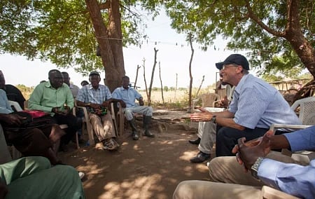 Bill Gates, discussing a school feeding programme supported by the Ministry of Agriculture with farmers in Accra, Ghana.
