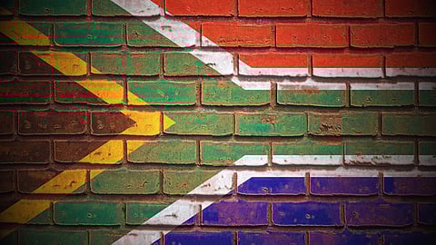 South Africa's flag painted onto a red brick wall.