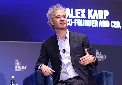 Palantir CEO Alex Karp, dressed smartly, delivering a talk on stage.