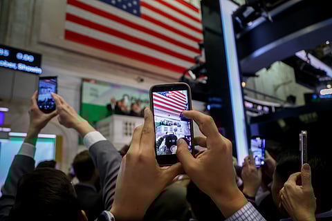 Cynthia Lo Bessette, head of digital asset management at Fidelity Investment Co., center, rings the opening bell on the floor of the New York Stock Exchange (NYSE) in New York, US, on Friday, Nov. 21, 2025. Wall Street traders drove stocks higher at the end of a volatile week that saw some of the most-speculative corners of the market getting whipsawed, testing investors' nerves after a relentless rally.