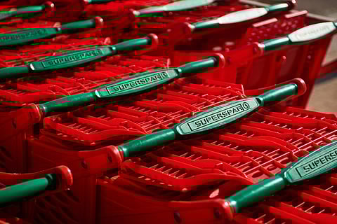 Shopping carts stacked outside a Spar Group Ltd. supermarket in the Die Wilgers suburb of Pretoria, South Africa, on Thursday, July 14, 2022.