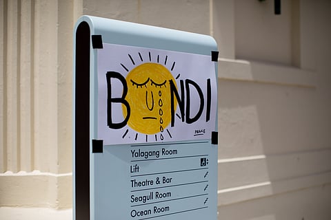 A sign of mourning near the scene of the mass shooting at Bondi Beach in Sydney, Australia, on Monday, Dec. 15, 2025. Twelve people have been killed in Australia's worst terrorist attack, as gunmen opened fire on Jewish people who had gathered to celebrate the first day of Hanukkah at Sydney's iconic Bondi Beach on Sunday evening. 