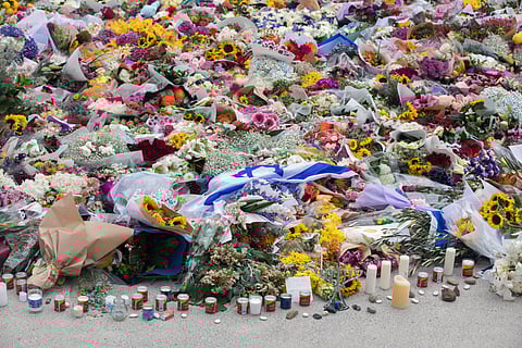 Flowers and candles placed near the site of the mass shooting at Bondi Beach in Sydney, Australia