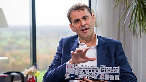 Hard to copy. Christophe Fouquet, boss of ASML, holds a model of a semiconductor lithography machine during a Bloomberg TV interview.