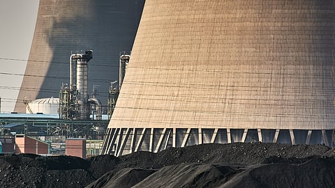 Coal supplies near cooling towers at Sasol Ltd.'s main plant in Secunda, Mpumalanga, South Africa.