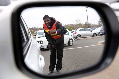 
EDENDALE, SOUTH AFRICA- AUGUST 15: Edmore David Kalonga, a car guard who returned thousands of Rands left by a patron on August 15, 2014 at Edendale Mall in Edendale, South Africa. Kalonga's honesty secured him a job as a stock despatch checker at a risk and asset management company. After hearing what the car guard did on Jacaranda FM, Gerhard van Zyl, general manager of Professional Risk and Asset management called into the radio station to offer Kalonga a job. He starts his job today. (Photo by Gallo Images / Sunday Times/ Jackie Clausen)