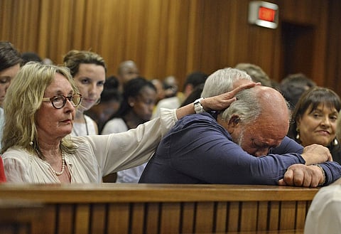 Barry Steenkamp, father of Reeva Steenkamp, is consoled by his wife June Steenkamp during the sentencing hearing of Olympic and Paralympic track star Oscar Pistorius at the North Gauteng High Court in Pretoria in this October 15, 2014 file photo. Pistorius is due to be released on Friday after serving 10 months of a five-year sentence, in line with South Africa's custodial guidelines for non-dangerous prisoners.   REUTERS/Antoine de Ras/Pool/Files FROM THE FILES PACKAGE "OSCAR PISTORIUS DUE TO BE RELEASED". SEARCH "PISTORIUS FILES" FOR ALL 20 IMAGES