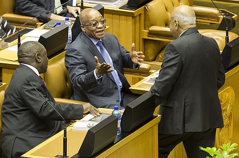 Jacob Zuma, South Africa's president, center, speaks to Cyril Ramaphosa, South Africa's deputy president, left, and Pravin Gordhan, South Africa's finance minister, right. Photographer: Halden Krog/Bloomberg
