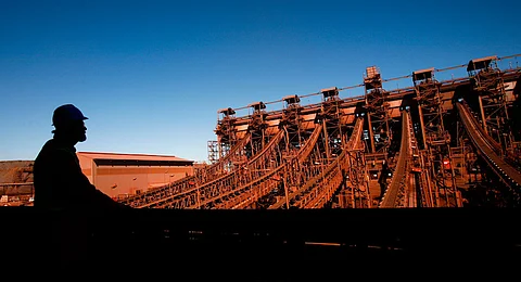 An employee monitors the processing of iron ore along conveyor belts in the Jig plant at Sishen mine, operated by Kumba Iron Ore Ltd., an iron ore-producing unit of Anglo American Plc, in Shishen, South Africa, on Wednesday, Aug. 24, 2011. Kumba Iron Ore Ltd. may decide on the next stage of its Sishen-Saldanha expansion in 2014, the company said in a presentation on its website today. Photographer: Nadine Hutton/Bloomberg