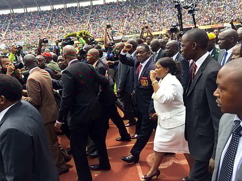 Emmerson Mnangagwa, Zimbabwe's president elect, center, and his wife, Auxilia Mnangagwa, acknowledge the crowd as they arrive for his presidential inauguration ceremony at the National Sport Stadium in Harare, Zimbabwe, on Friday, Nov. 24, 2017. Mnangagwa said democratic elections will be held on time next year and pledged to lead the revival of the economically distressed southern African nation. Source: Bloomberg