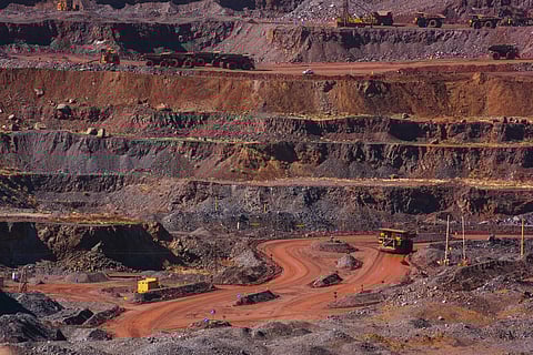 Excavators and dumper trucks operate in the open pit at the Sishen open cast mine, operated by Kumba Iron Ore Ltd., an iron ore-producing unit of Anglo American Plc, in Sishen, South Africa, on Tuesday, May 22, 2018. Kumba Iron Ore may diversify into other minerals such as manganese and coal as Africas top miner of the raw material seeks opportunities for growth and to shield its business from price swings. Photographer: Waldo Swiegers/Bloomberg