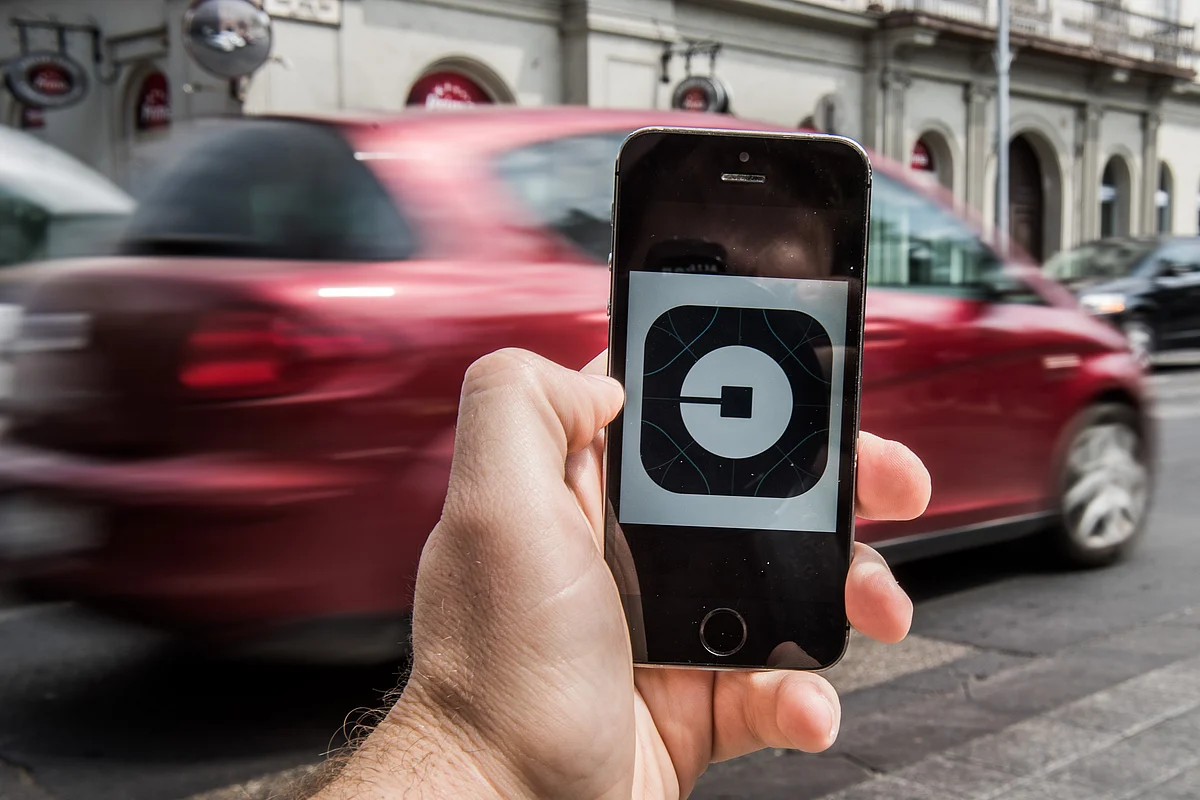 The Uber app displayed on an iPhone (Photographer: Akos Stiller/Bloomberg)