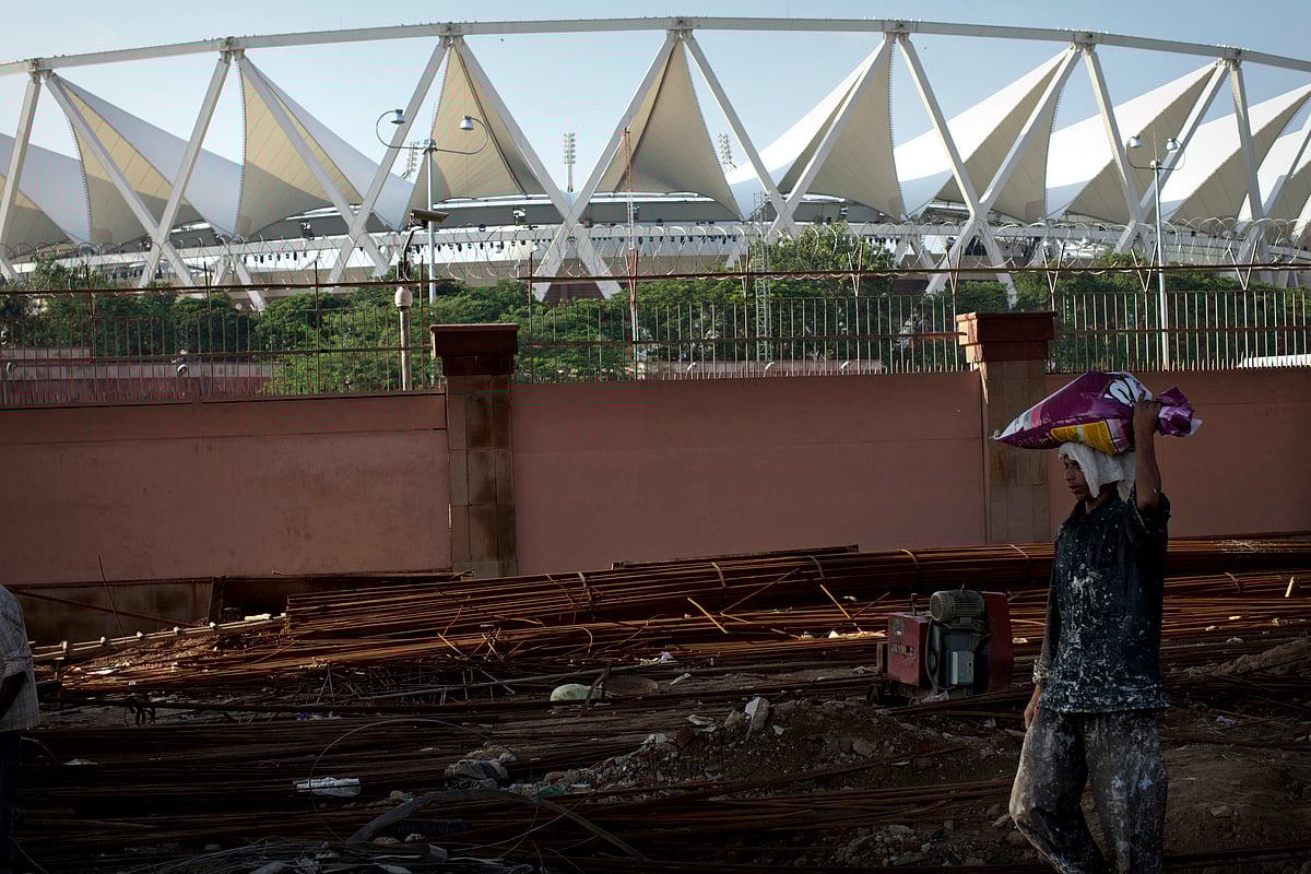 

A construction worker carries objects on his head at a construction site near the Jawaharlal Nehru Stadium, the primary venue for the Commonwealth Games, in New Delhi, India, on Saturday, Sept. 25, 2010. (Photographer: Brian Sokol/Bloomberg)