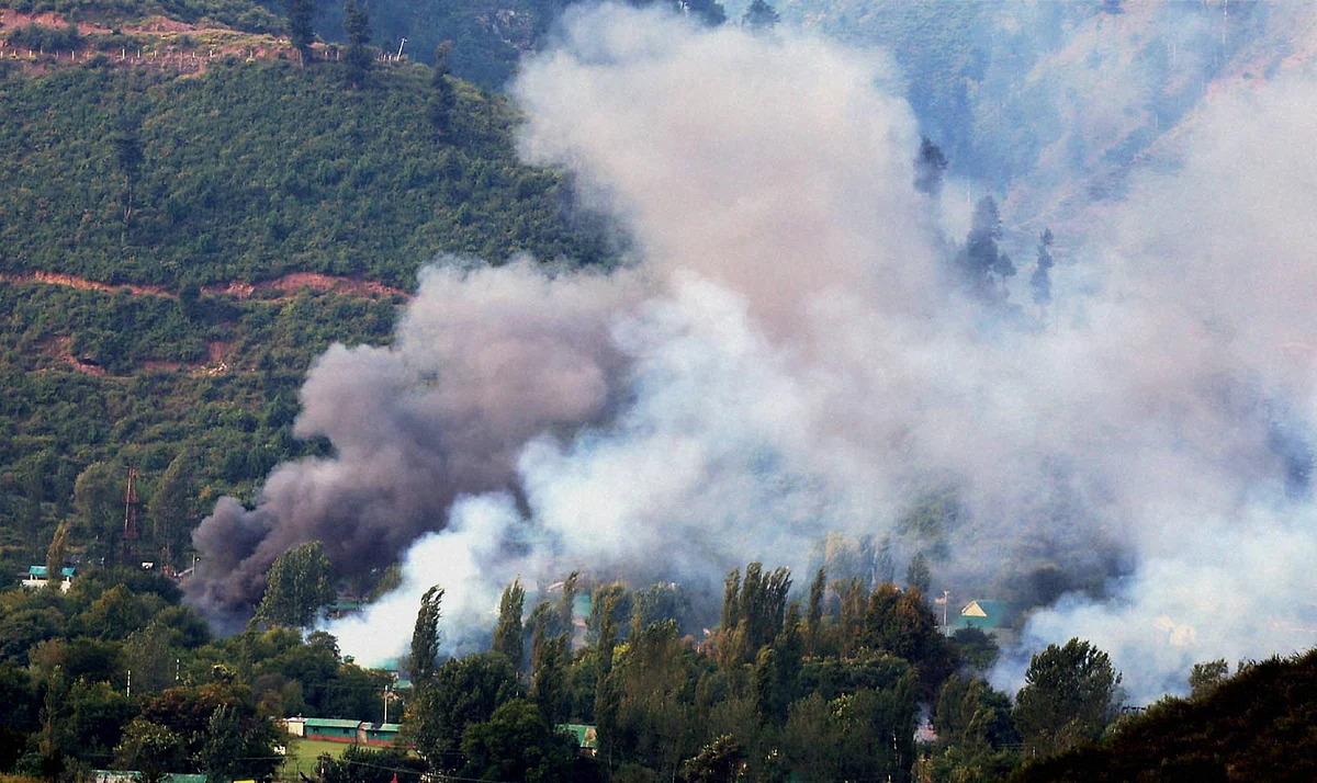 Smoke rises from the Army Brigade camp during a terror attack in Uri, Jammu and Kashmir on Sunday. (Source: PTI) 