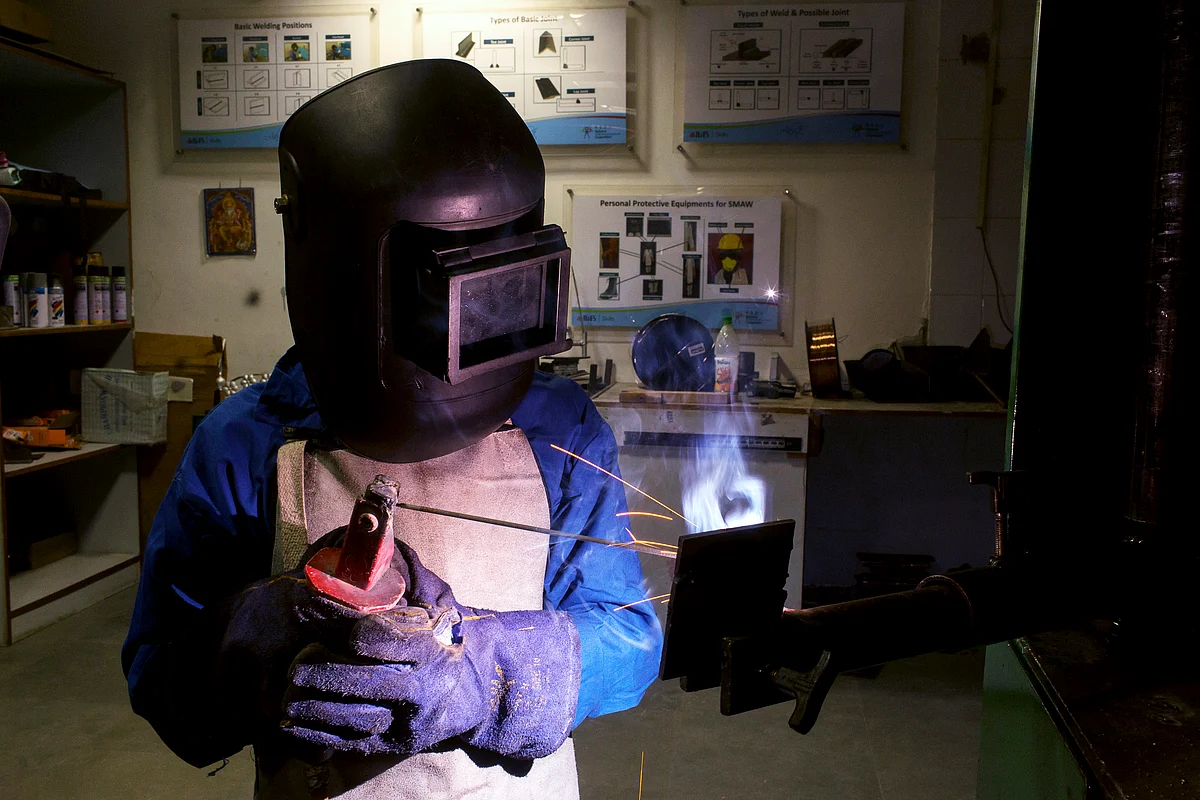 A student attends a welding class during vocational training at a skills centre in New Delhi. (Photograph: Udit Kulshrestha/Bloomberg)