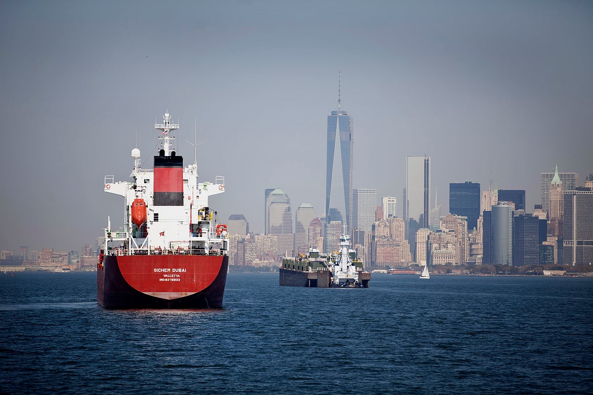 A chemical and oil tanker, left, and a barge, sit anchored in New York Harbor in New York. (Photographer: Ramin Talaie/Bloomberg)&nbsp;