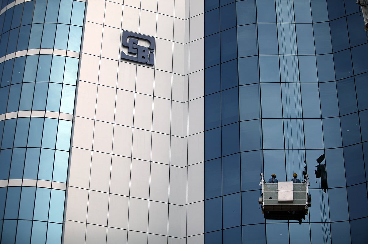 A worker cleans the glass of the Securities &amp; Exchange Board of India in Mumbai, India (Photographer: Adeel Halim/Bloomberg News) &nbsp;