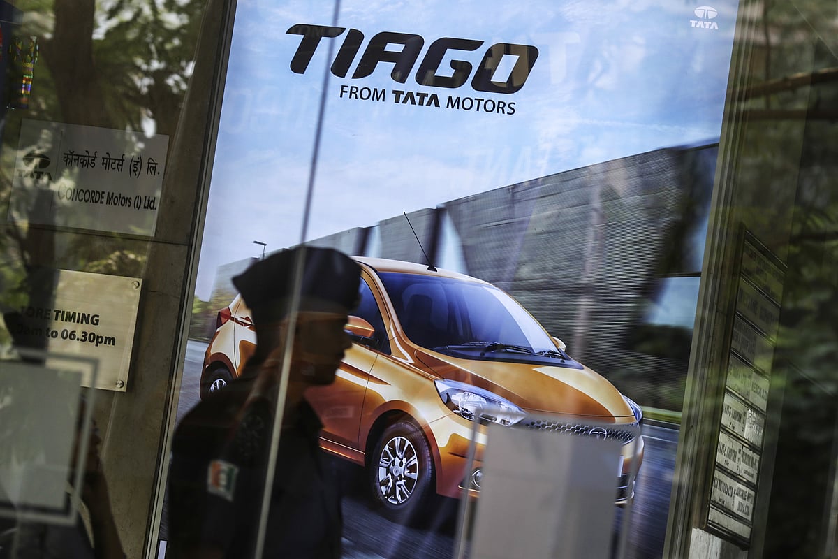 An advertisement for the Tata Motors Ltd. Tiago hatchback is displayed inside the Prabhadevi Concorde Motors India Ltd. dealership in Mumbai, India (Photographer: Dhiraj Singh/Bloomberg) 