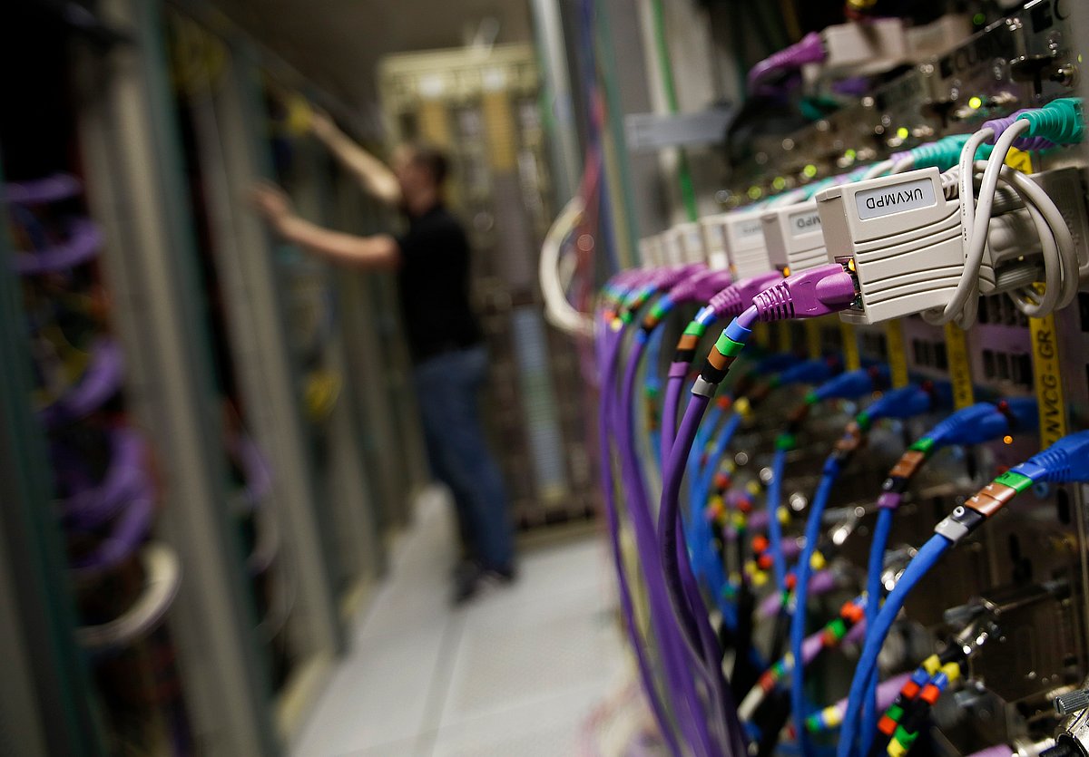 Rows of colored high end data cables are seen feeding into computer servers inside a comms room at a office (Photographer: Simon Dawson/Bloomberg) &nbsp;