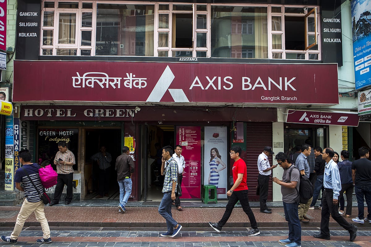 People walk past a branch of Axis Bank Ltd. (Photographer: Prashanth Vishwanathan/Bloomberg) &nbsp;
