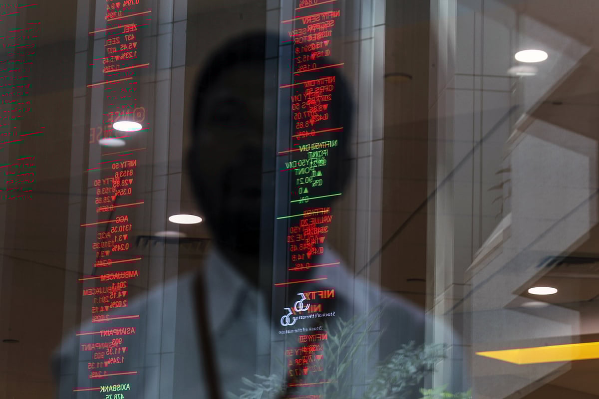 Electronic board indicating the latest stock figures are reflected in a glass facade at the National Stock Exchange of India Ltd. (NSE) in Mumbai, India. (Photographer: Dhiraj Singh/Bloomberg)
