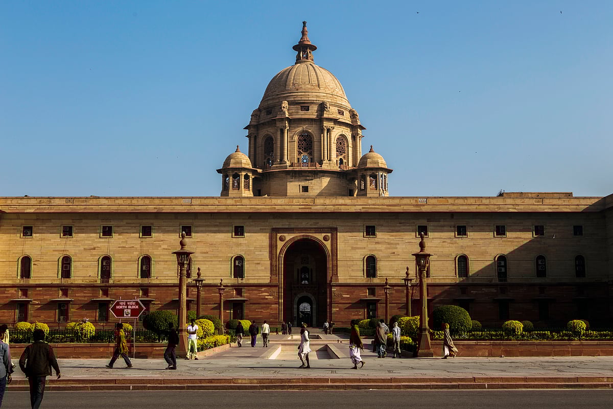 People walk outside the North Block which houses India’s Finance Ministry. (Photograph: Prashanth Vishwanathan/Bloomberg)