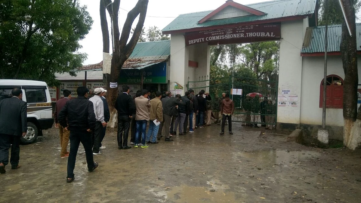 Government officials get frisked before heading into the Deputy Commissioner’s office in Thoubal. (Photo: The Quint/Maina Dutta)