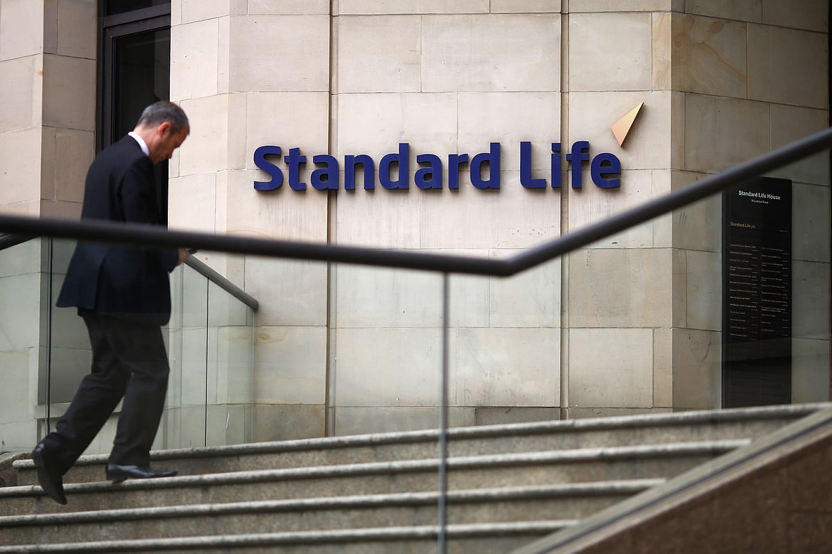 

A visitor climbs stairs leading to Standard Life House, the headquarters of Standard Life Plc, in Edinburgh. (Photographer: Simon Dawson/Bloomberg)