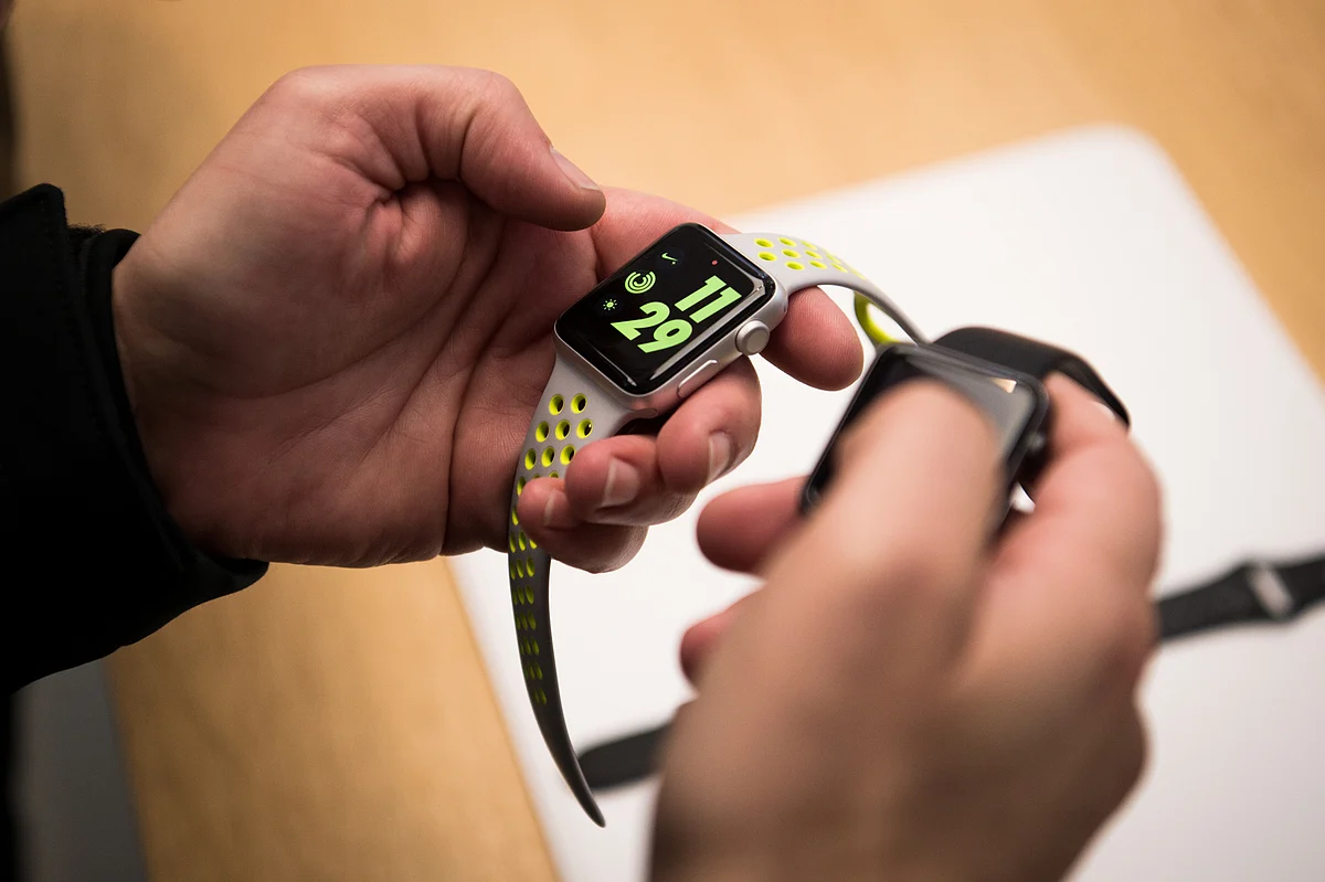 An employee points out new features on the Apple Watch Nike+ device at a store in the SoHo neighborhood of New York, U.S., on Friday, Oct. 28, 2016. (Photographer: Mark Kauzlarich/Bloomberg)