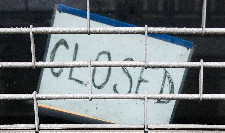 <div class="paragraphs"><p>A closed sign hangs from a door. (Photographer: Chris Ratcliffe/Bloomberg News)</p></div>