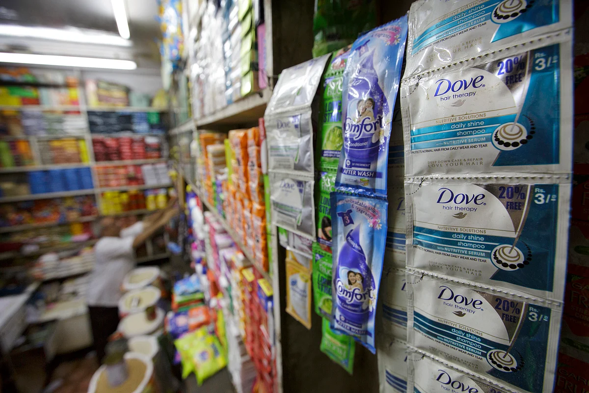 Sachets of Hindustan Unilever Ltd. Dove shampoo, from right, and Comfort laundry softener are displayed for sale at a store in Mumbai, India (Photographer: Kuni Takahashi/Bloomberg)
