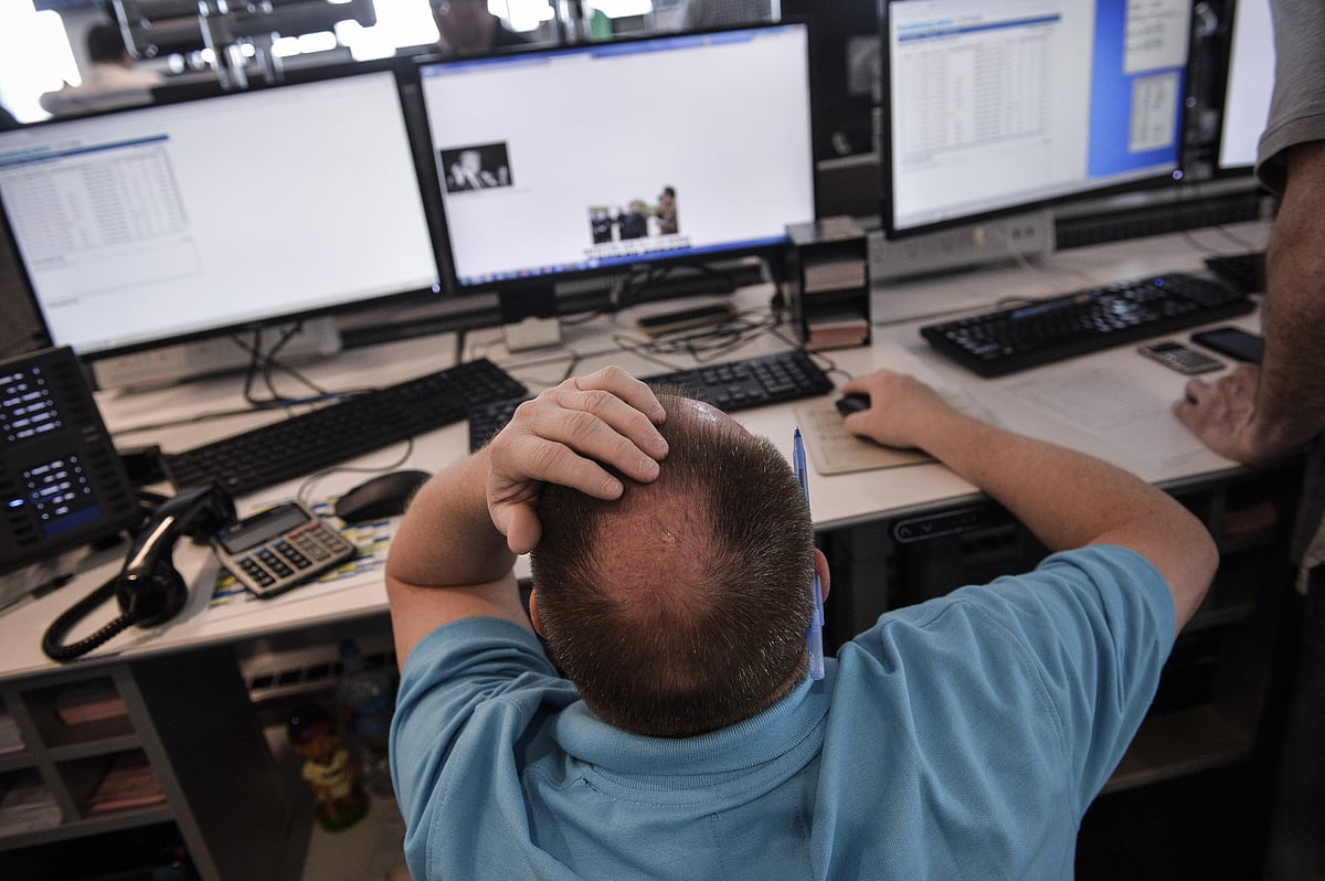 A trader works at the new Nasdaq Inc. trading floor of the Philadelphia Stock Exchange. (Photographer: Charles Mostoller/Bloomberg)