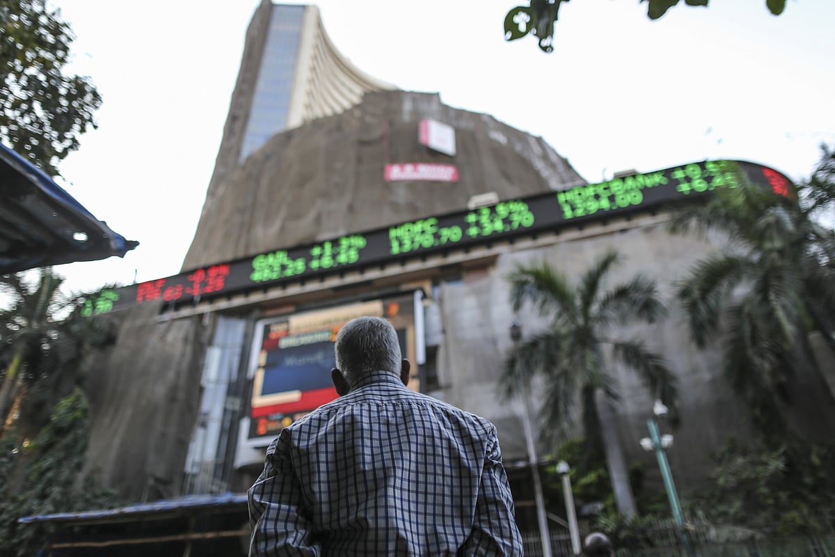 

A man looks up at an electronic ticker board that indicates stock figures at the Bombay Stock Exchange (BSE) in Mumbai, India. (Photographer: Dhiraj Singh/Bloomberg)