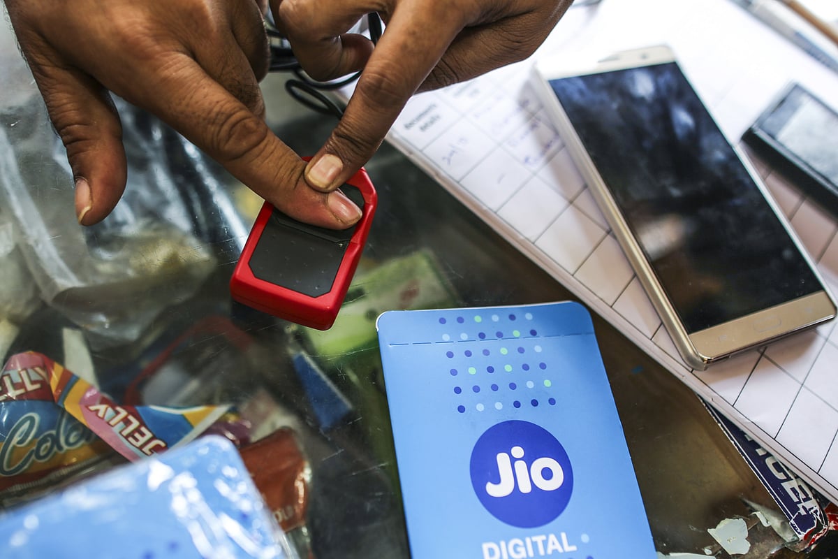 

A customer provides a finger print scan while connecting a mobile phone to the carrier Reliance Jio. (Photographer: Dhiraj Singh/Bloomberg)