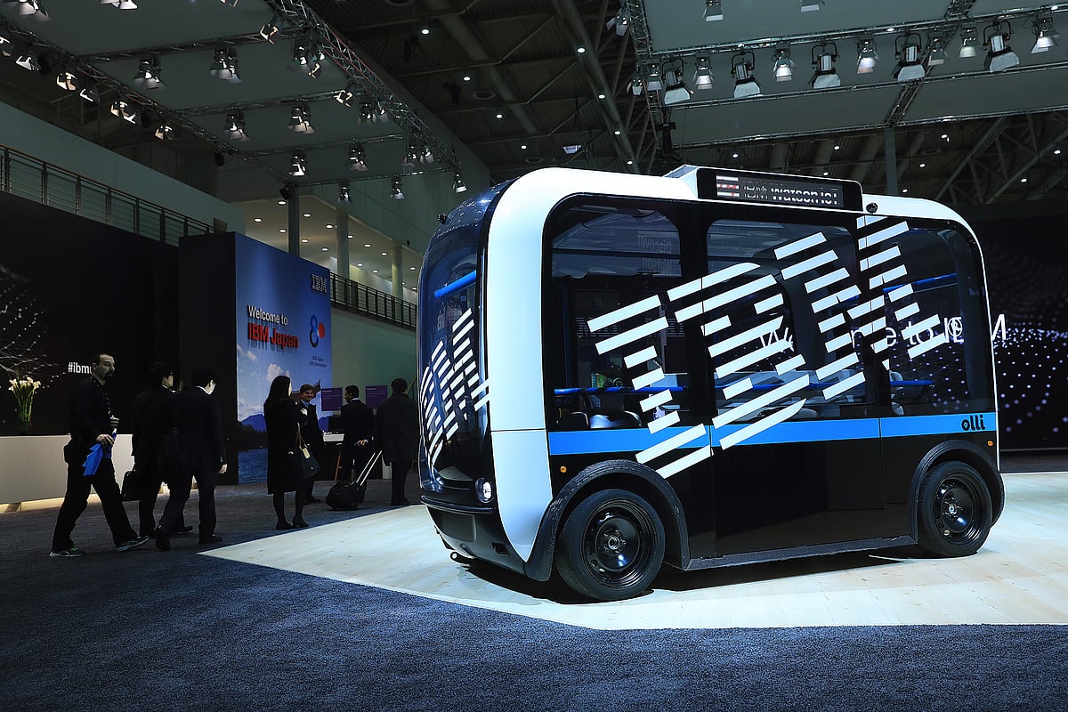 An International Business Machines Corp. (IBM) logo sits on the side of an ‘Ollie’ self-driving electric bus at the CeBIT 2017 tech fair in Hannover, Germany, on Monday, March 20, 2017. (Photographer: Krisztian Bocsi/Bloomberg)