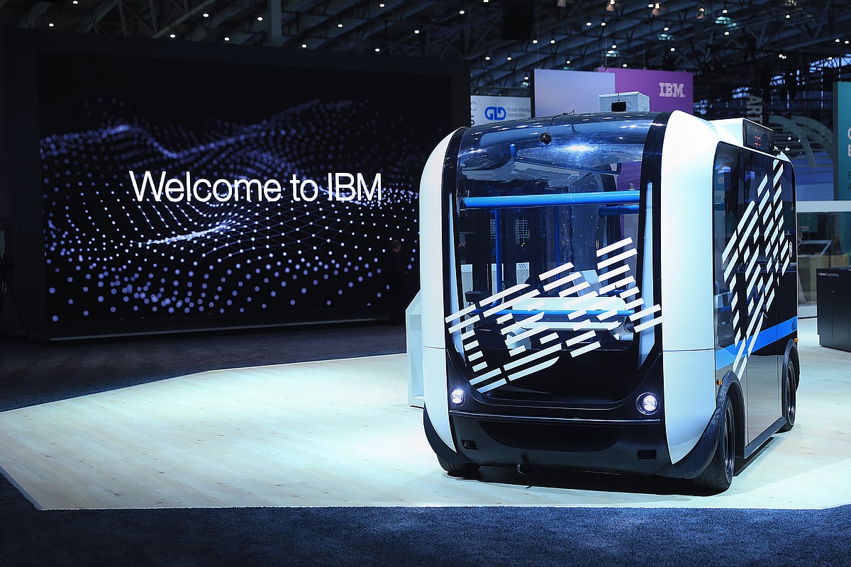 An International Business Machines Corp. (IBM) logo sits on the window of an ‘Ollie’ self-driving electric bus at the CeBIT 2017 tech fair in Hannover, Germany, on Monday, March 20, 2017. Leading edge technologies in the digital world are showcased in this annual event which runs March 20 - 24. (Photographer: Krisztian Bocsi/Bloomberg)&nbsp;