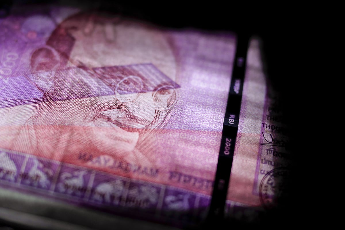 

An Indian two thousand rupee banknote is arranged for a photograph (Photographer: Dhiraj Singh/Bloomberg)