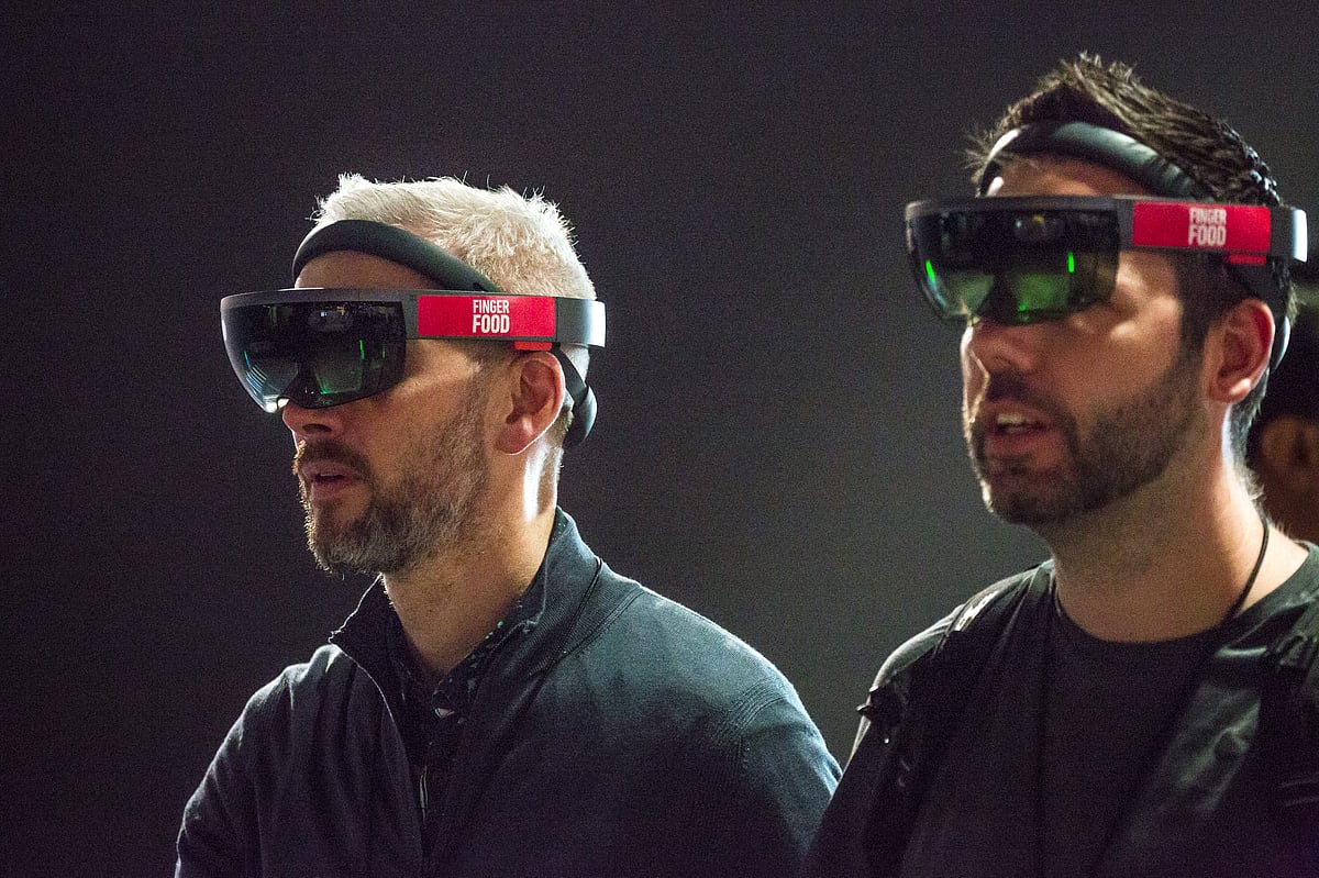 Attendees use Microsoft Corp. HoloLens virtual reality (VR) headsets during a product demonstration by Finger Food Studios at the Microsoft Developers Build Conference in Seattle, Washington, U.S. (Photographer: David Ryder/Bloomberg)