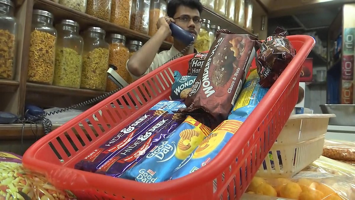 Packets of biscuits manufactured by Parle Products Pvt. Ltd. and Britannia Industries Ltd. on display in Gayatri Dry Fruits and General Stores in Crawford Market, Mumbai. (Photographer: Vivek Amre/BloombergQuint)