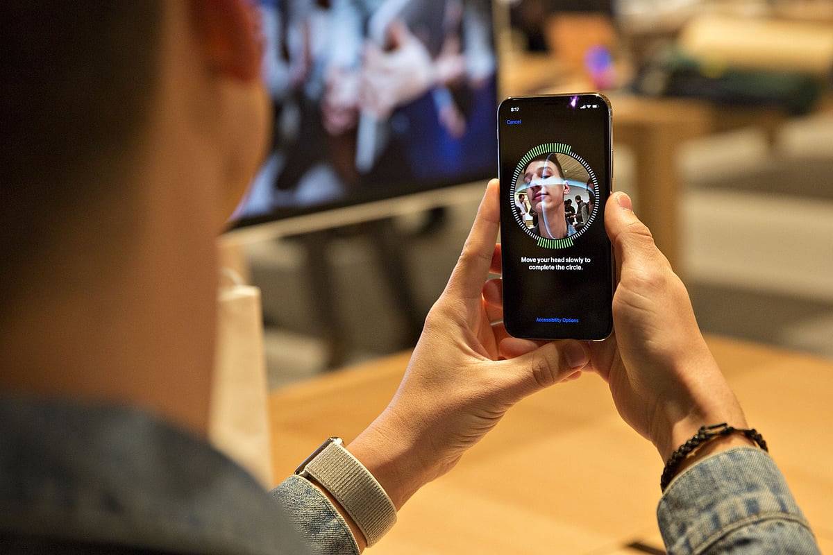 A customer sets up facial recognition on an Apple Inc. iPhone X smartphone during the sales launch at a store in Chicago, Illinois, U.S. (Photographer: Daniel Acker/Bloomberg)