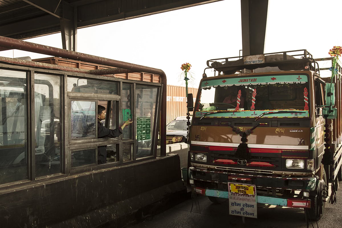A truck stops at a toll booth. (Photographer: Udit Kulshrestha/Bloomberg)