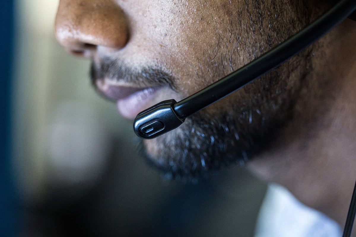 An employee wears a headset while working at the Avise Techno Solutions LLP call center in Kolkata. (Photograph: Taylor Weidman/Bloomberg)