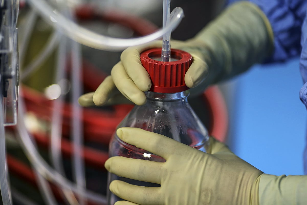 An employee in protective clothing works inside the research and development center. (Photographer: Dhiraj Singh/Bloomberg)